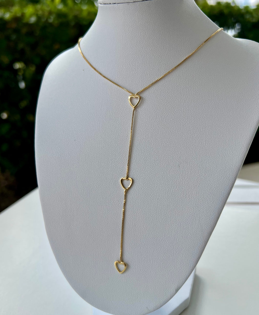 Thin golden necklace with pendant hearts